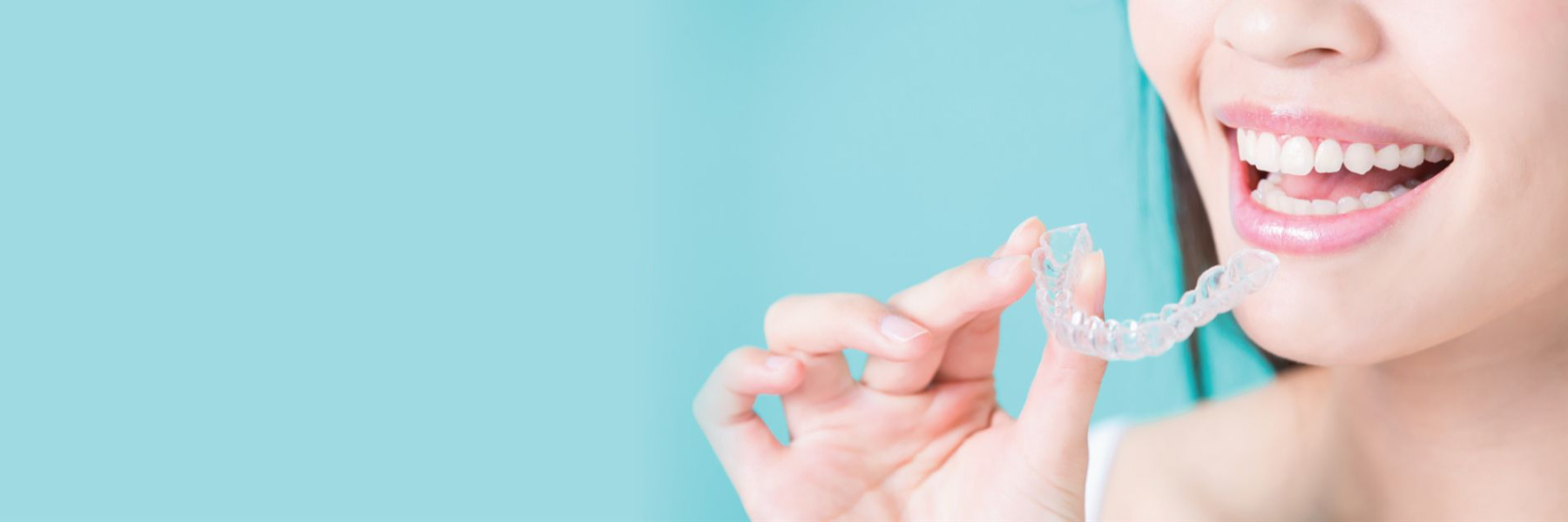 Patient holding a clear aligner in Arvada