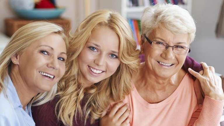 Family smiling because they see their Arvada dentist regularly